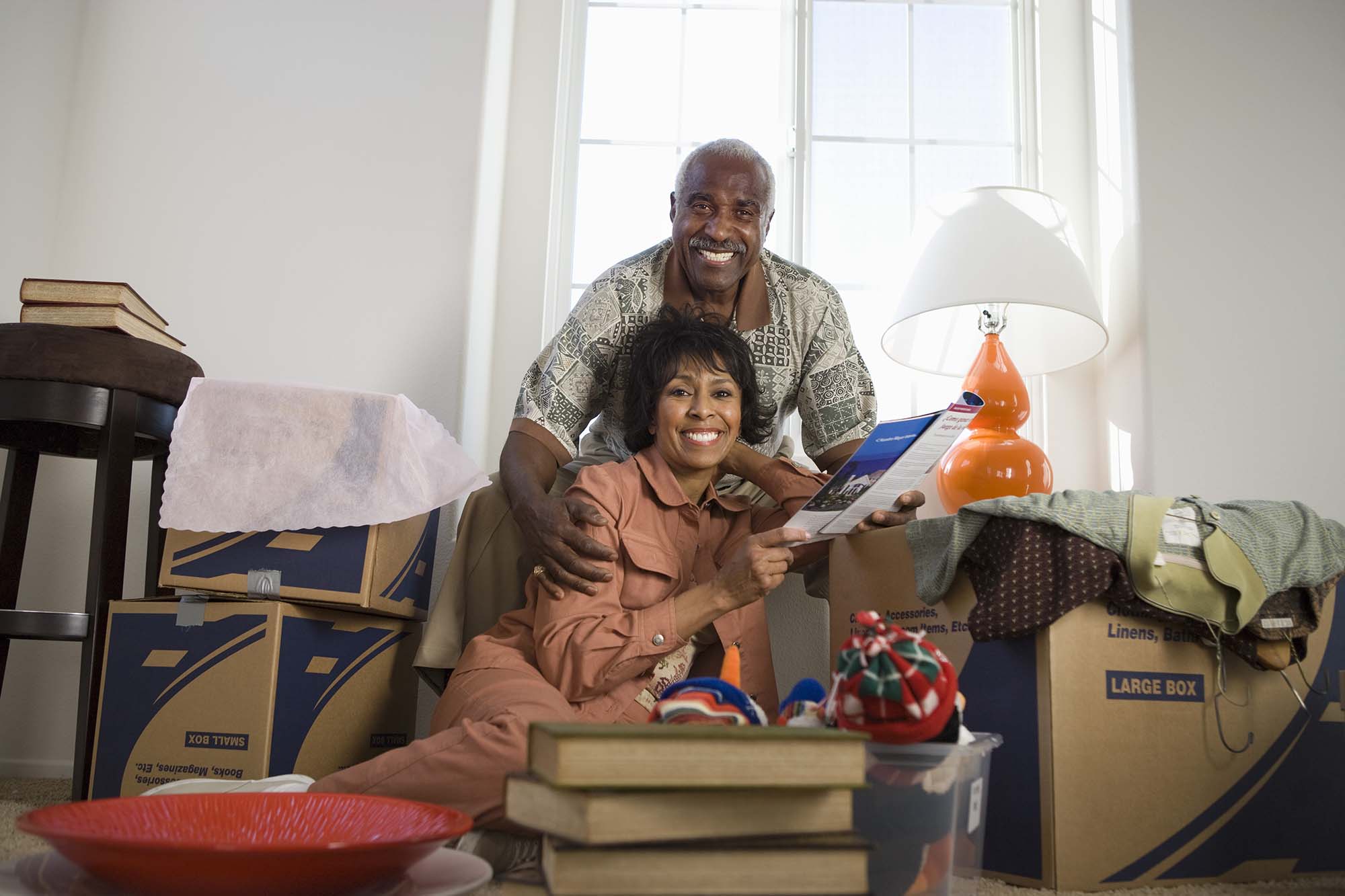 Senior Couple downsizing and unpacking in their new home