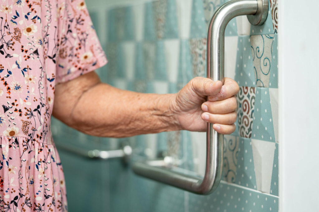 mature woman holding onto support bar